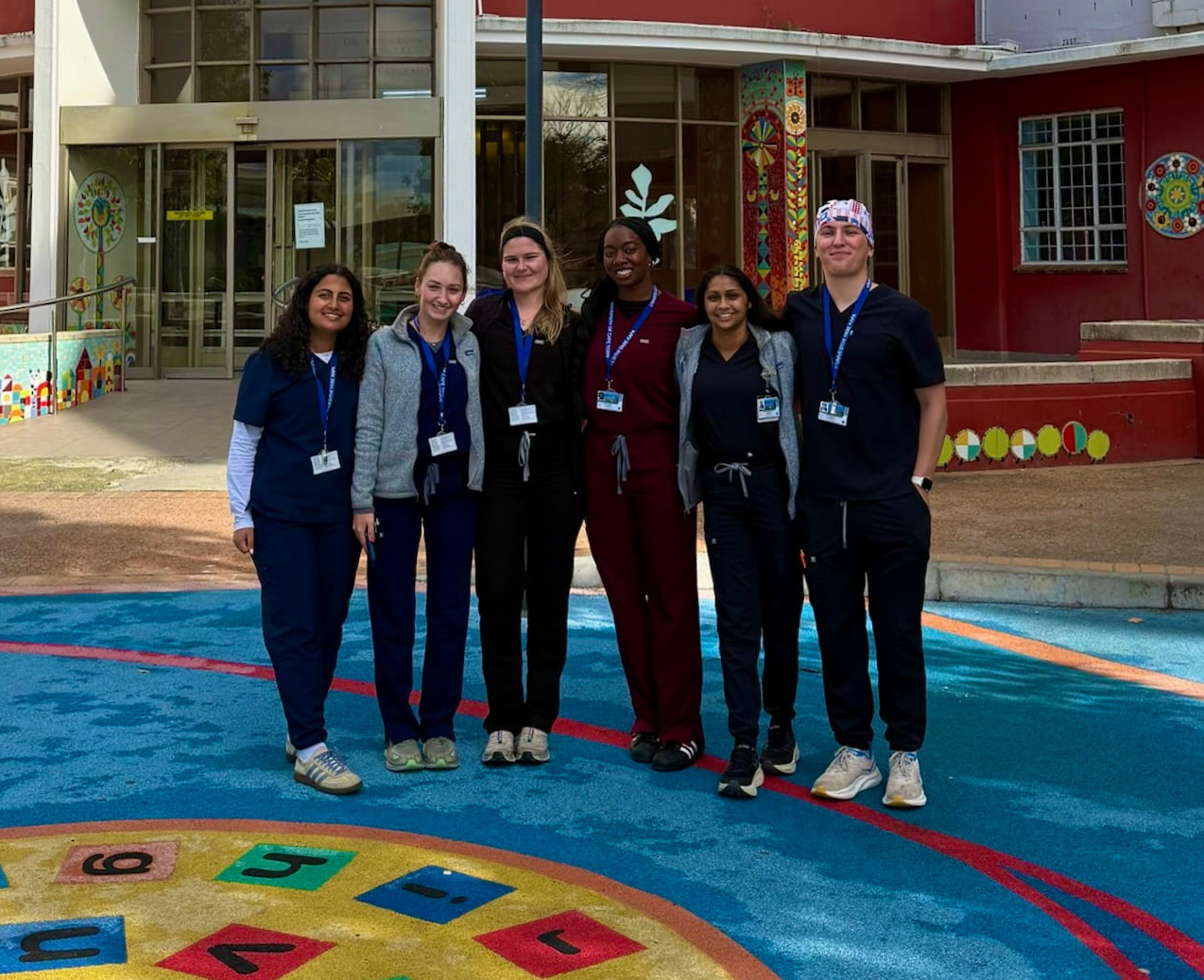 Medical students gather in front of a building
